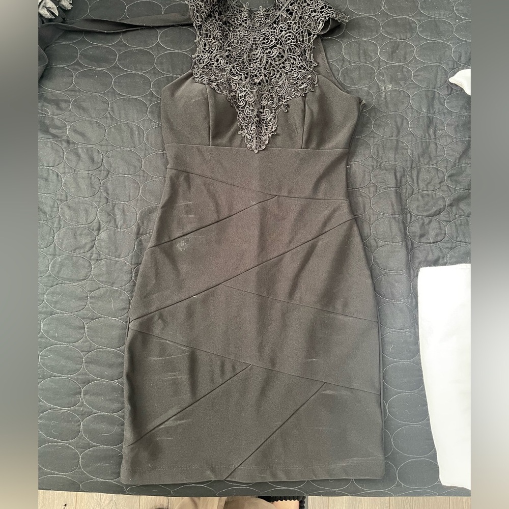 Fitted little black dress with lace detail on top